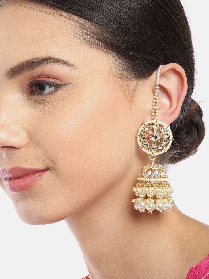 These gorgeous flower & dome shaped jhumki earrings come with kundan stone studs and off-white beaded danglers, are gold-plated, and secured with a post and back closure. Comes with beaded detachable ear chains. These handcrafted jhumkis can be styled with any traditional outfit, or an evening outfit to complete a dazzling look. Product color may vary based on the monitor or screen you are using.See FAQ for more details. Size Length of earring: 5.5 cmLength of ear chain: 10.5 cm Details Material Indian Earrings With Chain, Ear Chain Designs, Jhumka With Ear Chain, Ear Chain Traditional, Polki Designs, Climbers Earrings, Desi Jewellery, Earrings With Chain, Flower Dome