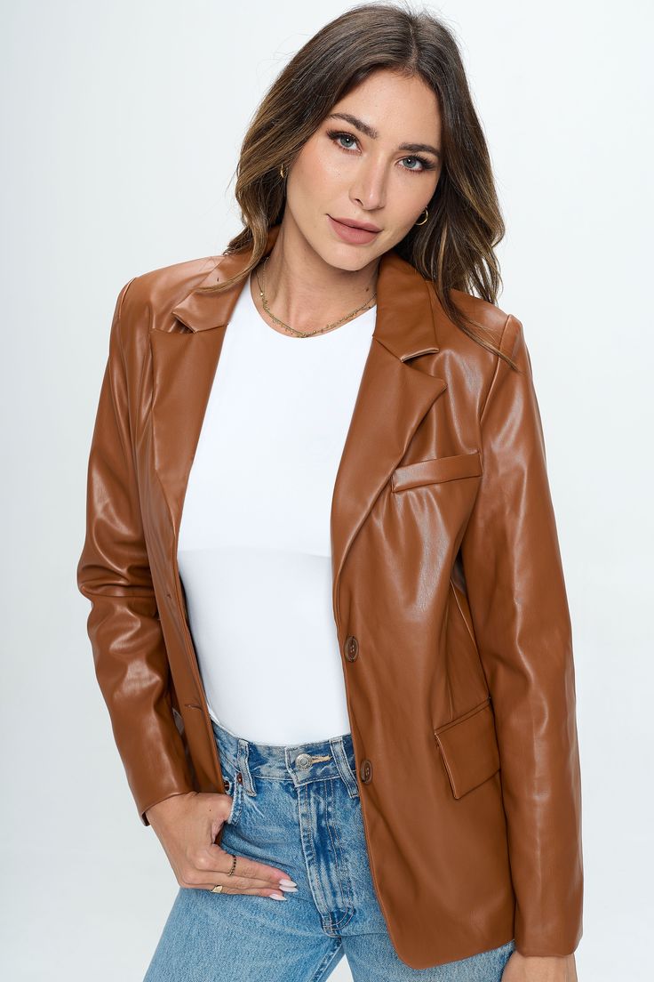 A structured fit in an earthy hue lend endless wearability to this faux leather blazer. Pair with a bodysuit and your favorite denim for an elevated, trendy look. Product Details Material: 100% Polyester. Fit: True to size. Structured fit. Body length: 27" from shoulder to hem (size Small). Fabric: Faux leather with satin lining. Features: Single breasted stacked buttons, front pockets, chest pocket, shoulder pads, satin lining. Model: 5'9" / Wearing a size Small. Shipping & Returns Free Shippin Fitted Faux Leather Blazer For Fall, Spring Fitted Faux Leather Blazer, Trendy Fitted Brown Leather Jacket, Trendy Brown Fitted Leather Jacket, Fitted Faux Leather Jacket With Notch Lapel, Trendy Single Breasted Faux Leather Jacket, Sleek Fitted Brown Outerwear, Sleek Brown Leather Jacket For Fall, Fitted Faux Leather Blazer With Notch Lapel