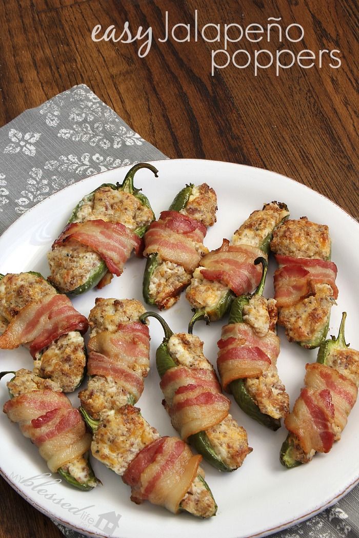 bacon wrapped jalapeno peppers on a white plate