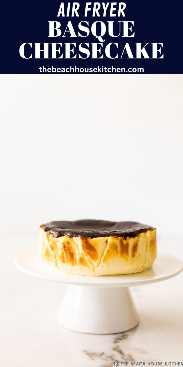 an air fryer cheesecake on a white cake plate with the title above it