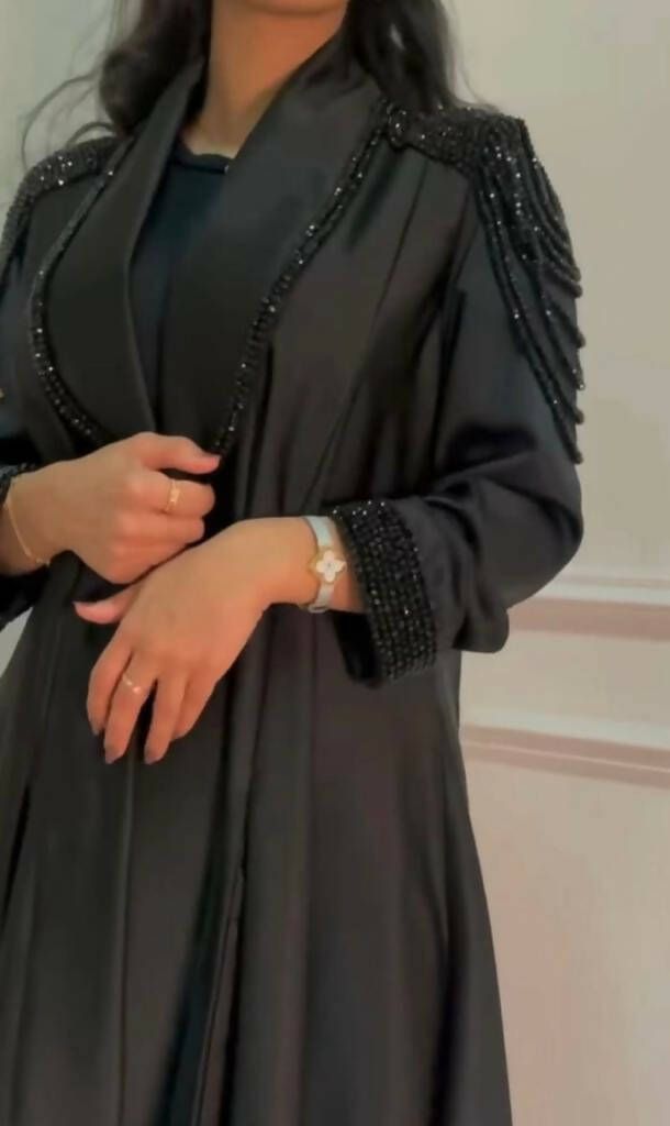 A gorgeous kimono style abaya perfect for the summer months, Ramadan, Eid, or any special occasions. Styling details include hand stitched diamonds and crystals on premium Nida fabric around the sleeves and on the lower sides of the abaya. Discreet snap fastener buttons inside the sleeve for added comfort. You are bound to receive compliments with this elegant piece. No refunds No exchanges final sale pricesCustomised productplease note that the Abaya may at times, have minimal & slight imperfec Work Abaya, Mode Kimono, Mode Abaya, Abaya Designs, Abaya Dress, Abayas Fashion, Abaya Fashion, Hijab Style, Color Free