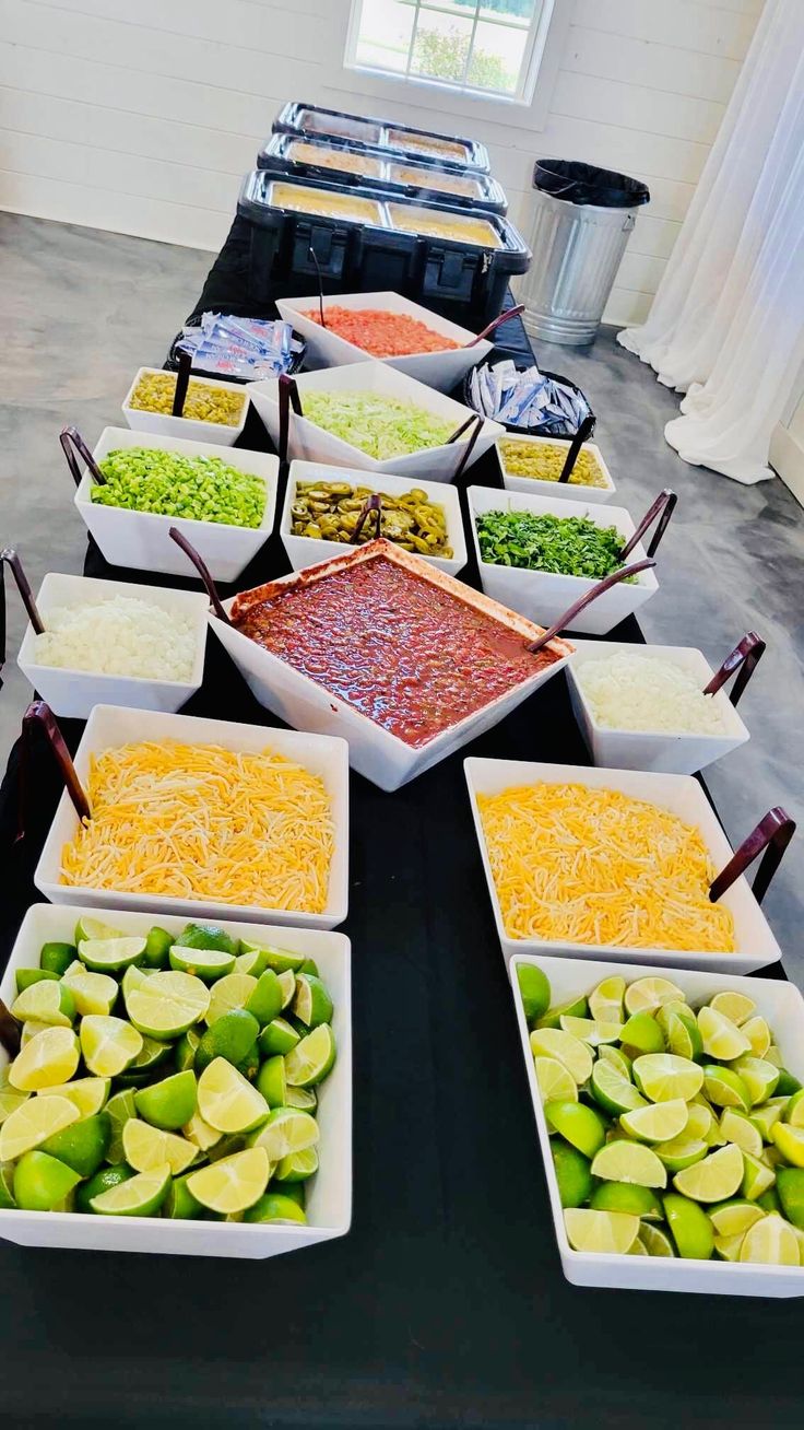 a table topped with lots of different types of food and bowls filled with condiments