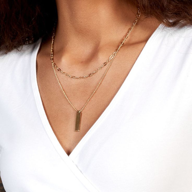 Be fabulous in this 14k gold plated layering necklace set that combines personalized beauty and modern glamour. The rectangle pendant is personalized with your initial and hangs from a satellite chain which is paired with a delicate chain to create an iconic look. Be fabulous day or night with this stunning necklace set. Available in 14k gold plated brass Maisie Pendant: Size: 1" by 1/4"; Length: 17" satellite chain with 2" extender Vivi Necklace: Size: 4mm; Length: 16" chain with 2" extender Lo Elegant Gold Bar Necklace For Layering, Elegant Layering Necklace With Rectangular Pendant, Elegant Rectangular Pendant Necklaces For Layering, Elegant Rectangular Pendant Necklace For Layering, Chic Gold Rectangular Chain Necklace, Chic Rectangular Gold Chain Necklace, Elegant Personalized Necklace With Rectangular Links, Elegant Gold Rectangular Bar Necklace, Gold Plated Rectangular Pendant Charm Necklace