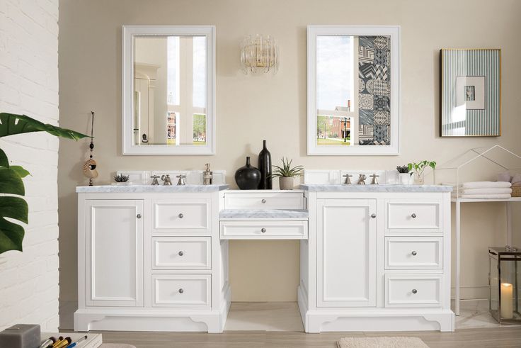 a bathroom with two sinks and mirrors on the wall