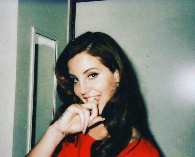 a woman in a red shirt posing for the camera