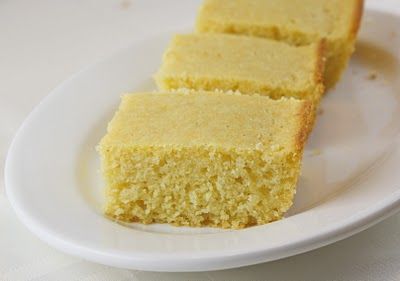 three slices of yellow cake on a white plate