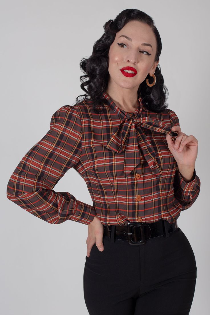 Sometimes you find a blouse that answers all of your questions. What is the meaning of life? Is it 42? No, it's the Clara Bow Blouse! This long sleeve harvest plaid blouse has a beautiful bow detail at the neckline. It's comfy, fashionable, and everything you could ask for! Pair it with one of our jumpers or skirts or make it an outfit with the matching Clara Skirt in the same, beautiful harvest plaid! Classic Plaid Blouse, Feminine Fall Blouse With Bow, Fall Plaid Cotton Blouse, Fitted Plaid Vintage Blouse, Slytherin Costume, Jumper And Skirt, High Neck Shirts, Plaid Cotton Button-up Blouse, Clara Bow