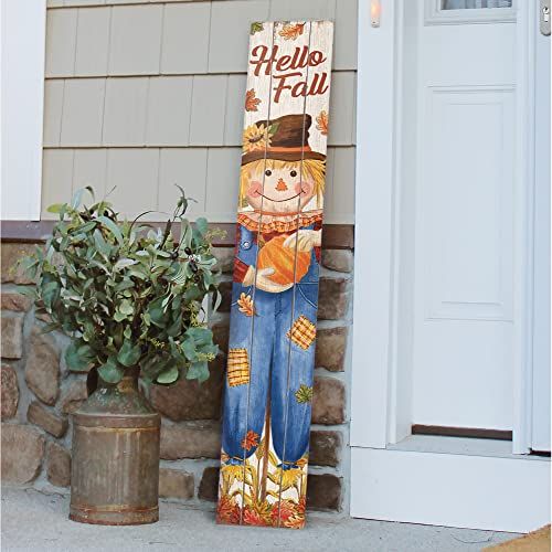 a wooden sign that says hello fall next to a potted plant on the front porch