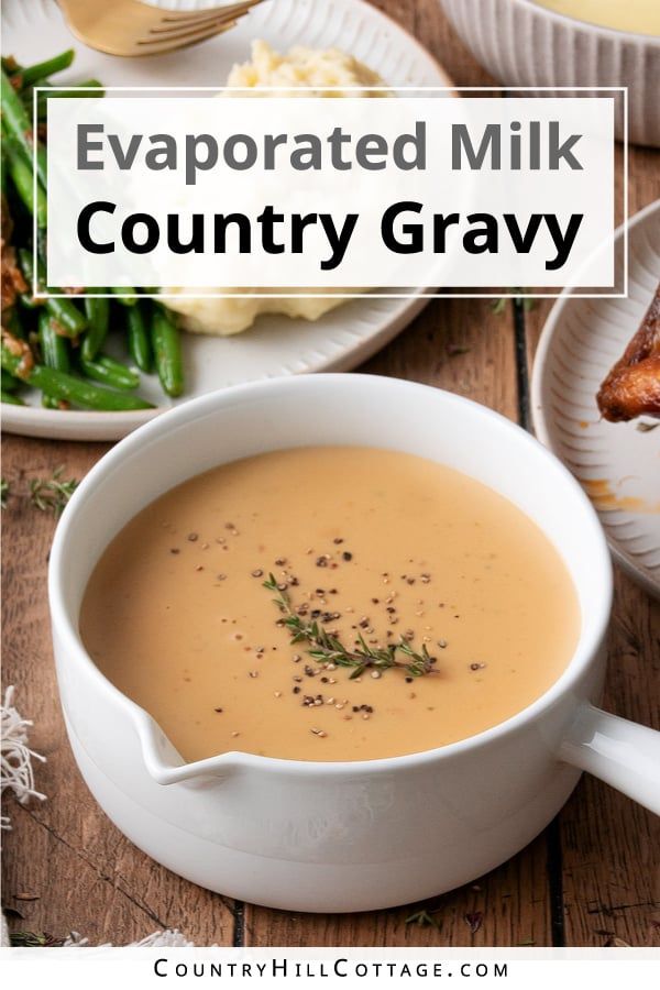 a bowl filled with soup next to other dishes on a wooden table and text overlay reads evaporated milk country gravy