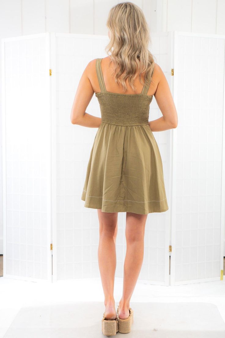 Say hello to the  Olive Fit & Flare Linen Mini Dress  - a flirty and fabulous piece made for all those summer adventures. With its flowy fit and mini length, this cute green dress is the ultimate go-to for every occasion. Whether you're out foraging mushrooms in the wild or enjoying a casual coffee date, the Murphy Mini Dress has got your back - keeping you looking cozy and cute, always! Embrace your unique style and let the fun begin!  Features:  Sweetheart neckline for a touch of romance. Pock Summer A-line Cotton Mini Dress, A-line Mini Dress With Smocked Back For Day Out, Flowy Cotton Mini Dress, Flirty Short Mini Dress For Spring, Cotton Summer Mini Hem Dress, Summer Fit And Flare Mini Dress With Smocked Back, Mini Summer Sundress For The Beach, Mini Dress With Smocked Back For Vacation, Flirty A-line Flowy Mini Dress