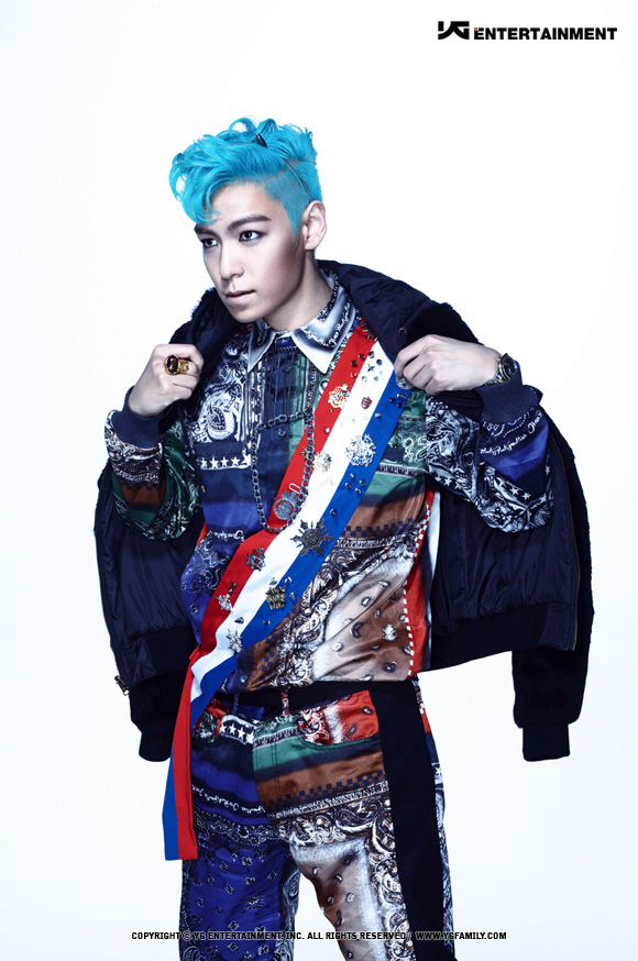 a man with blue hair is posing for the camera