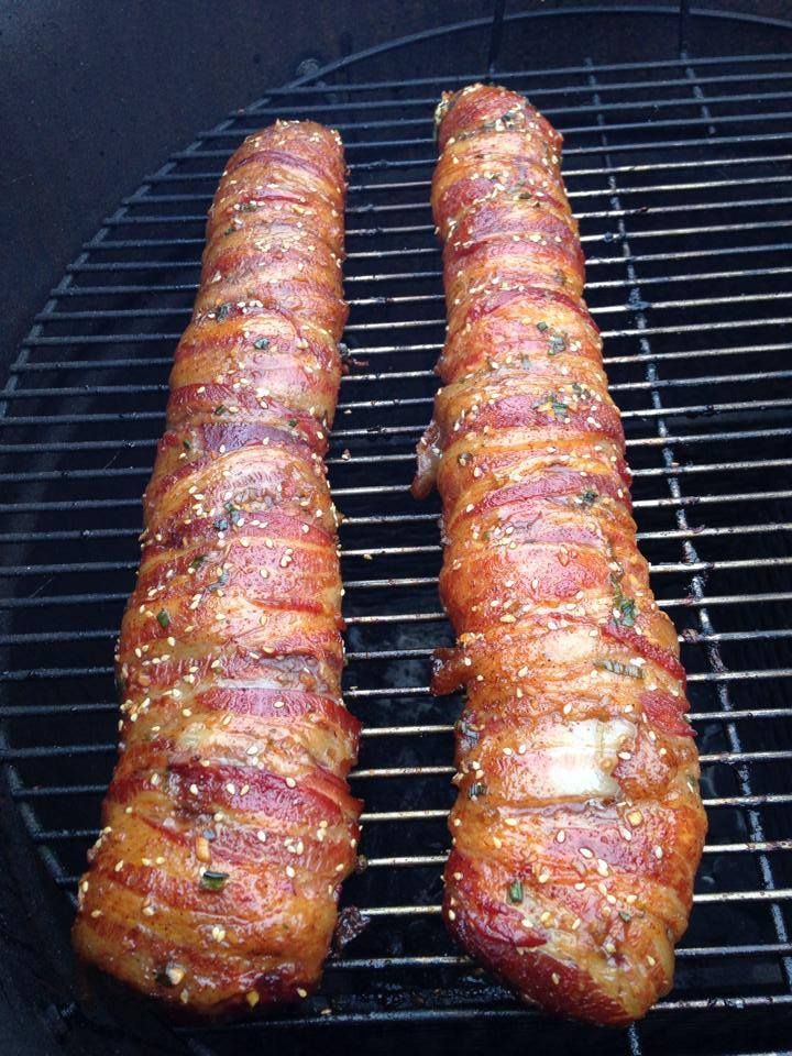 two sausages are being cooked on a grill