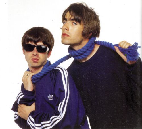 two young men with sunglasses on their heads and one wearing a blue scarf around his neck