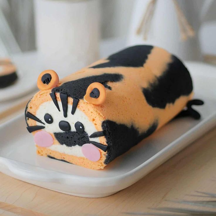 a cake shaped like a tiger sitting on top of a white plate