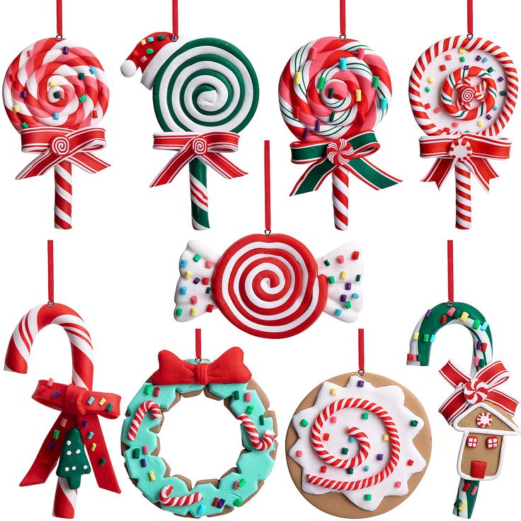 christmas ornaments are hanging from red and green pinstripe ribbons with candy canes on them