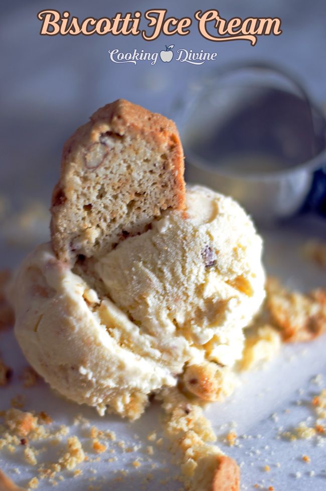 two scoops of ice cream sitting on top of a white plate with crumbs