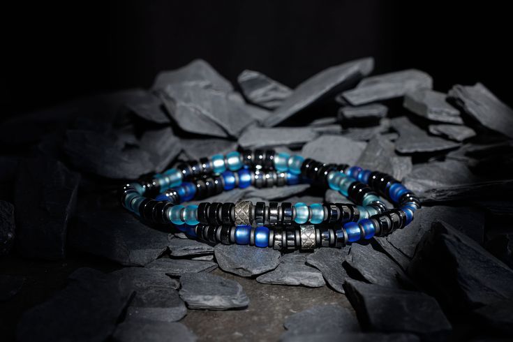 About Specifications Complete your outfit with our Dark Hematite Blue Bracelet I Handcrafted in The Netherlands by professional artisans with the best Nature has to offer and finished with 925 Sterling Silver. - Gems: Hematite & Miyuki Glass - Stone size: 6mm - Metal: 925 Sterling silver - Cord: High-end durable silicone - Packaging: Comes with a linen pouch (Due to the unique characteristics of natural stone, the size and color of the beads can vary slightly.) Modern Blue Beaded Bracelets As Gift, Modern Blue Beaded Bracelets For Gift, Handmade Modern Blue Beaded Bracelets, Modern Handmade Blue Beaded Bracelets, Modern Blue Handmade Beaded Bracelets, Silicone Packaging, Linen Pouch, Unique Opal, Best Nature