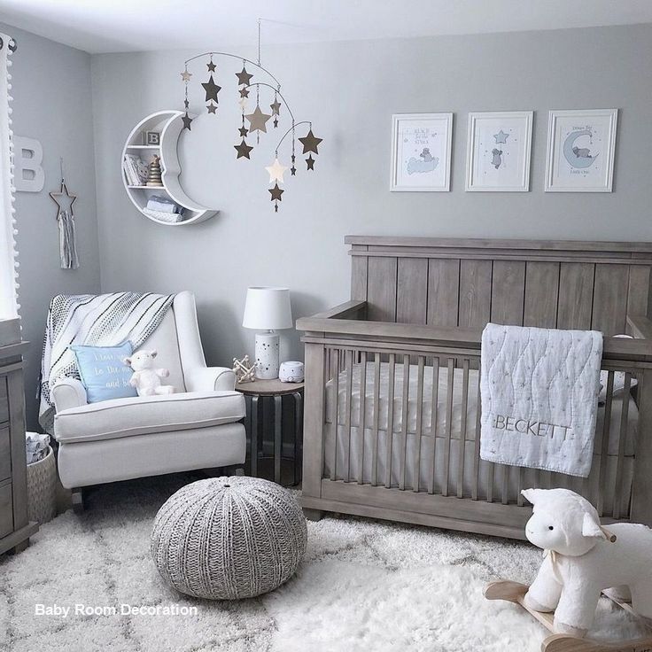 a baby's room with gray walls and white furniture