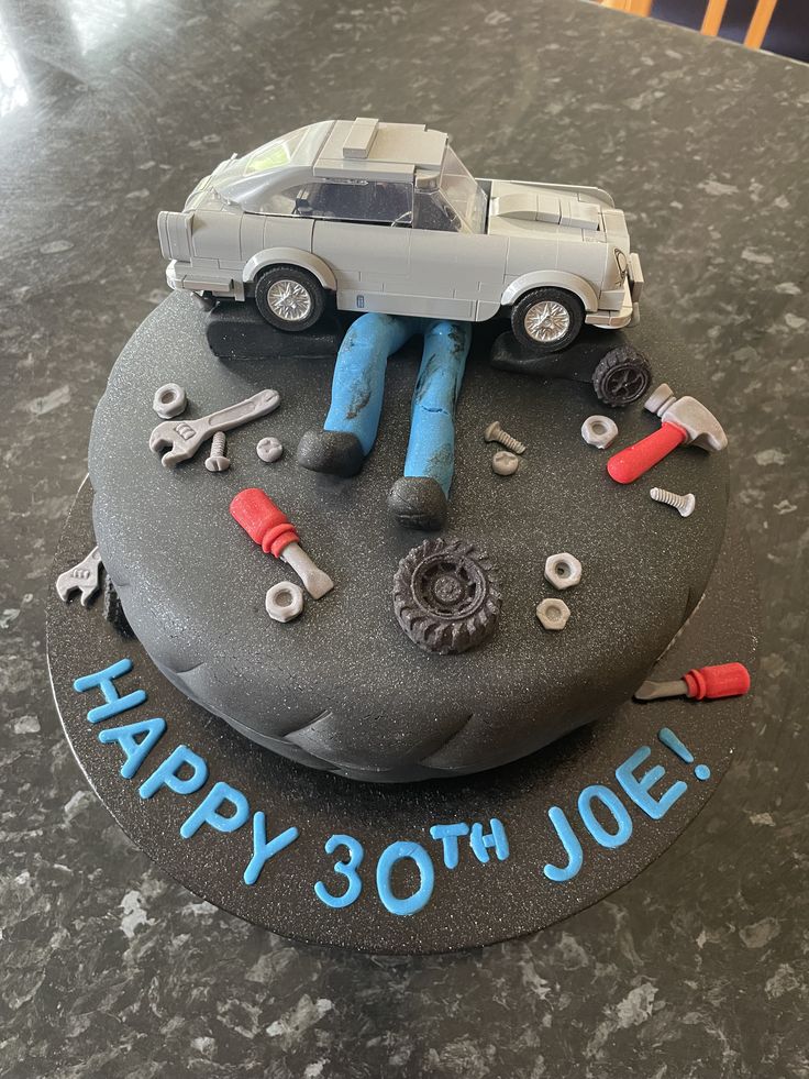 a birthday cake with a car and tools on it