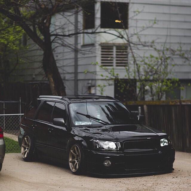 a black car parked in front of a building