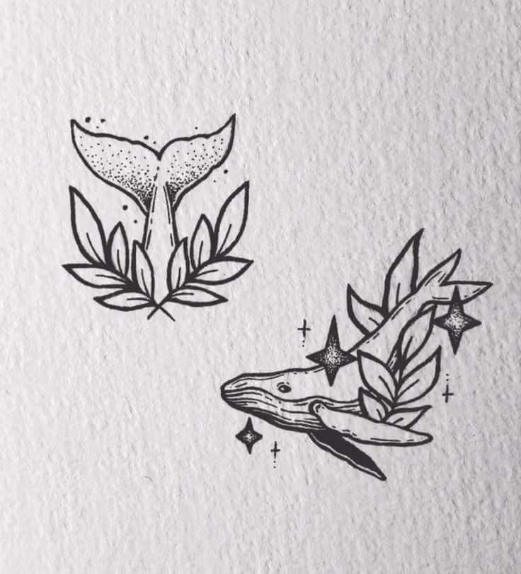 two whale tails with leaves and stars on them