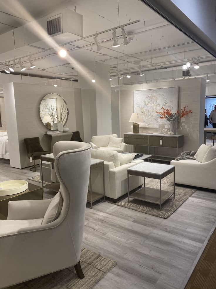 a living room filled with lots of white furniture