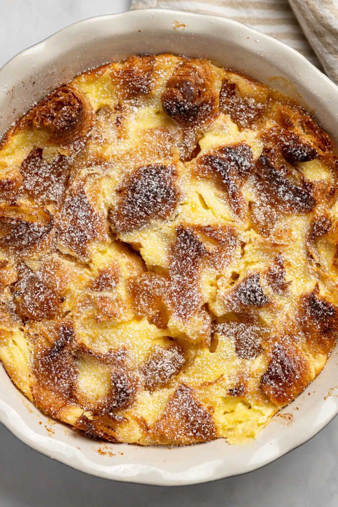 a casserole dish is shown with powdered sugar on the top and in the bottom