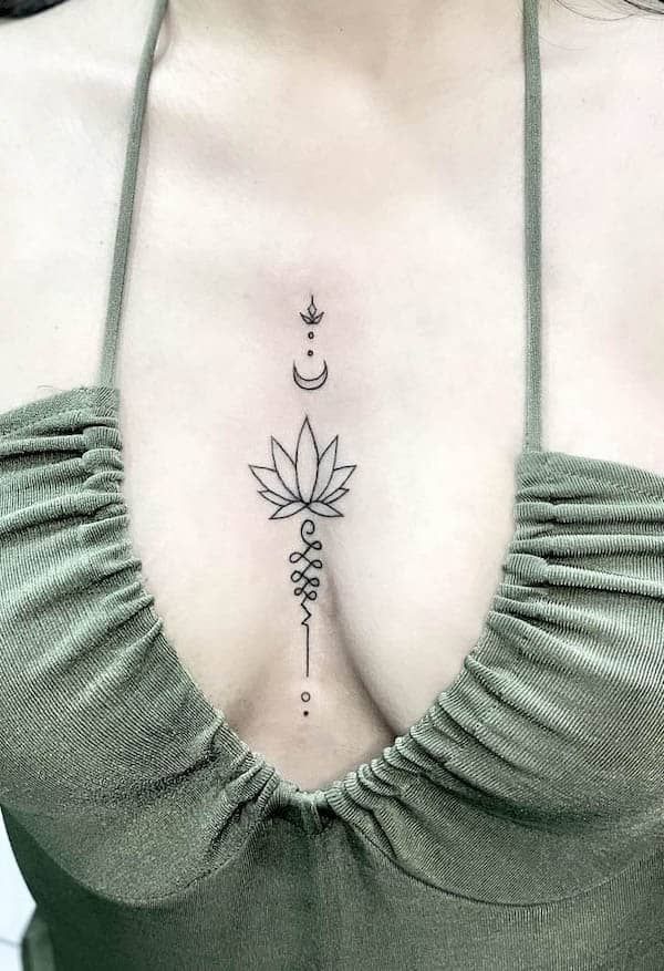 a woman's chest with a flower and crescent tattoo on her left side breast