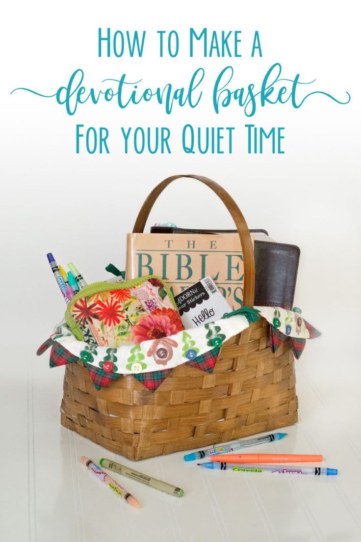 a basket filled with books, pens and other items on top of a white table