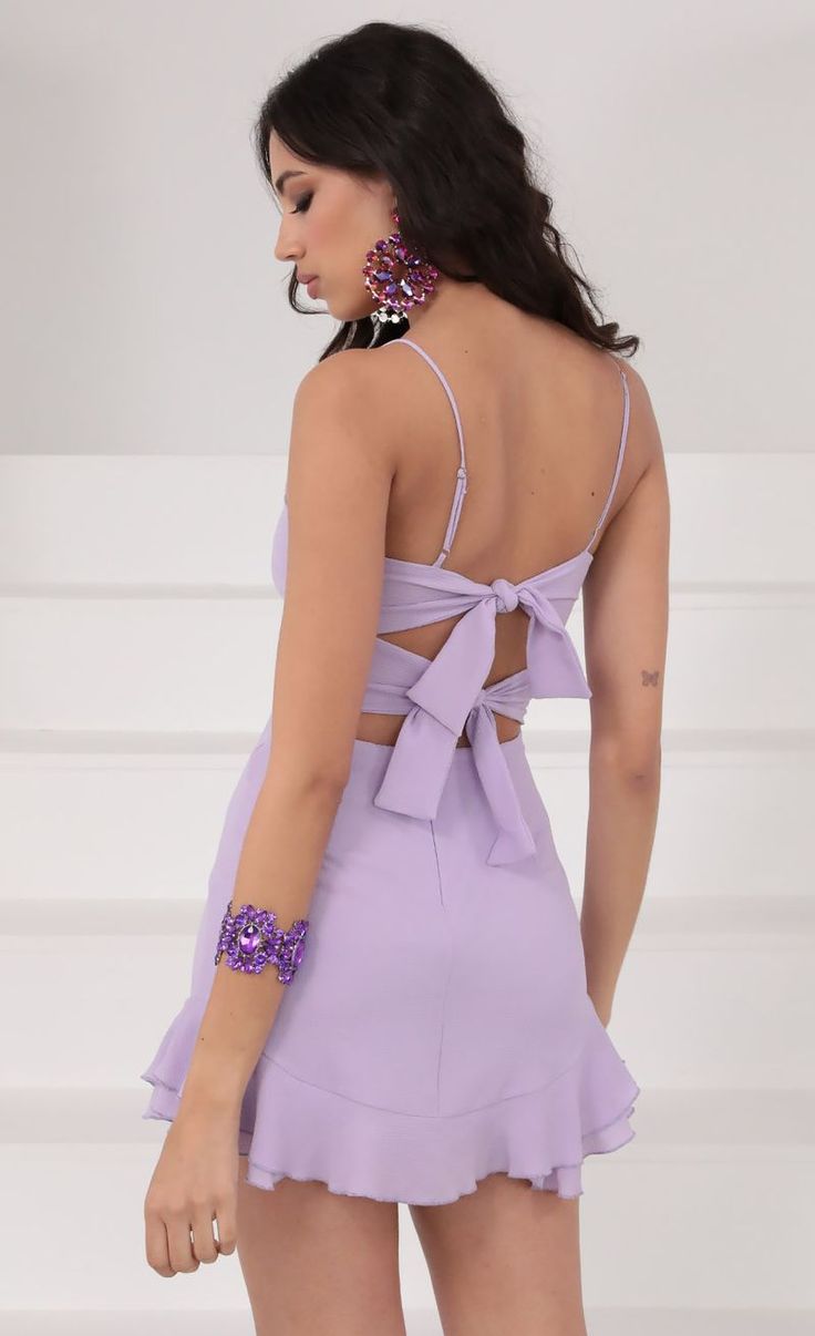 Ruffle Dress in Lavender | LUCY IN THE SKY Chic V-neck Mini Dress For Wedding Guest, Solid Color Dresses For Date Night And Party Season, Feminine Solid Color Mini Dress For Party, Feminine Solid Color Party Dress, Feminine Tie Back Mini Dress For Party, Flirty Solid Color Dress For Date Night, Spring Tie-back Mini Dress, Sleeveless Spring Wedding Guest Dresses, Sleeveless Tie Back Mini Dress For Party Season