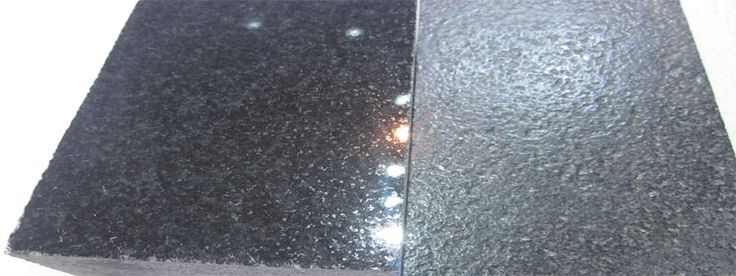 two pieces of black granite sitting next to each other