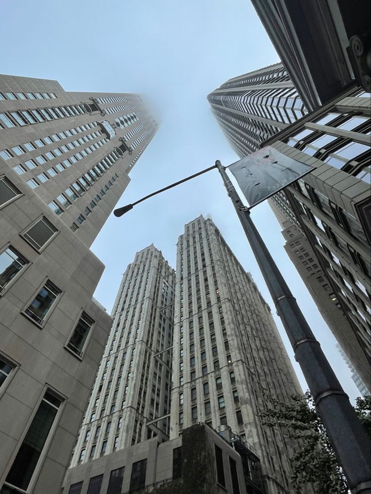 looking up at tall buildings in the city