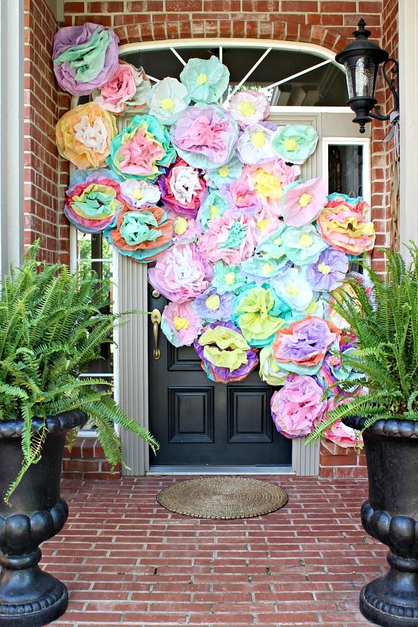 the front door is decorated with colorful paper flowers