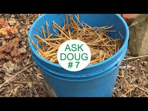 a blue bucket filled with straw and a sticker that says ask doug 7