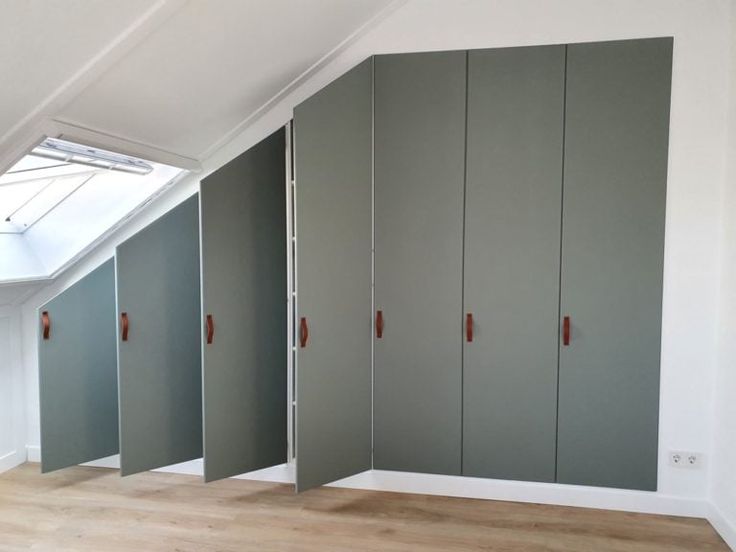 an empty room with green cabinets and white walls