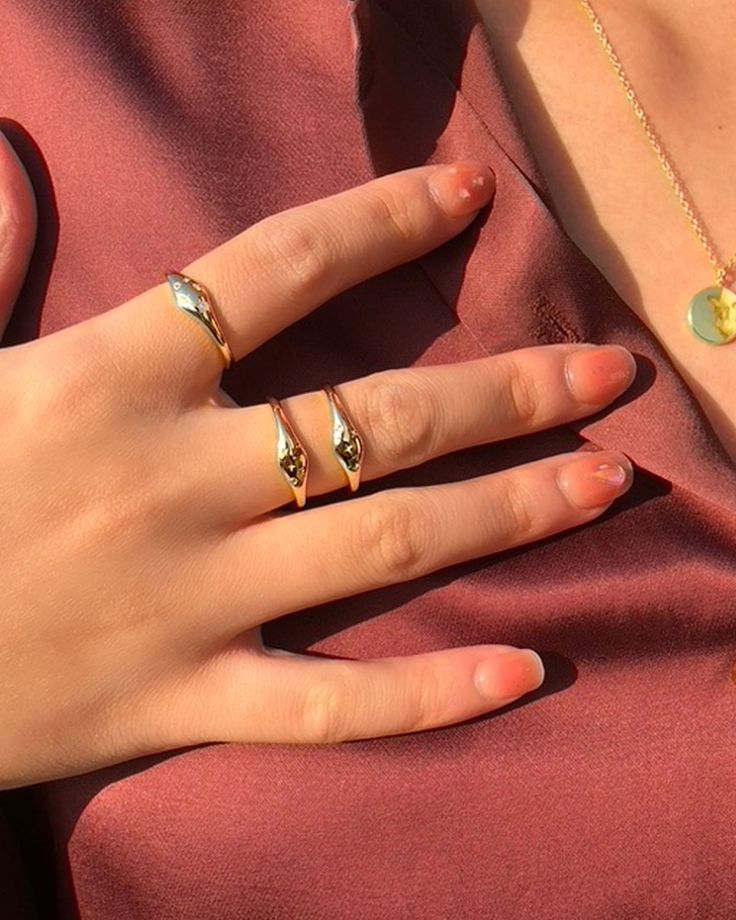 a woman's hand with two rings on it