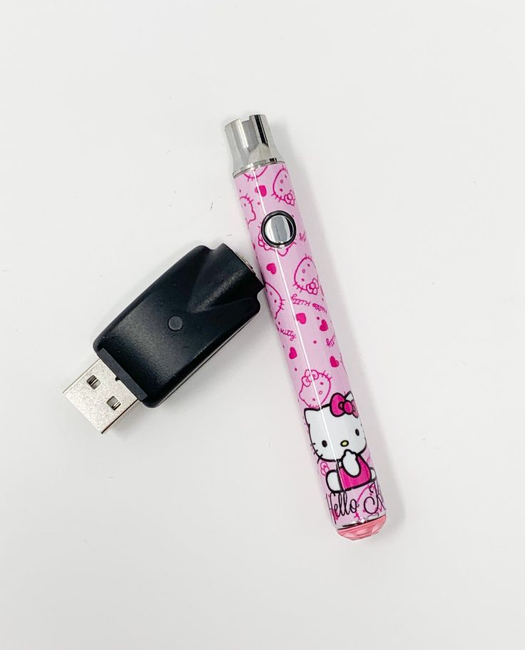 an electronic device with hello kitty on it and a keychain attached to it