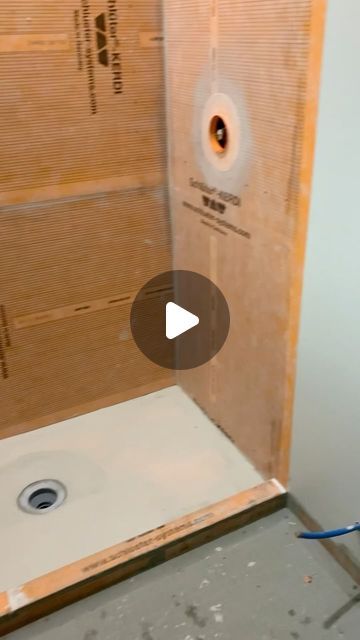 a bathroom being remodeled with the shower door open