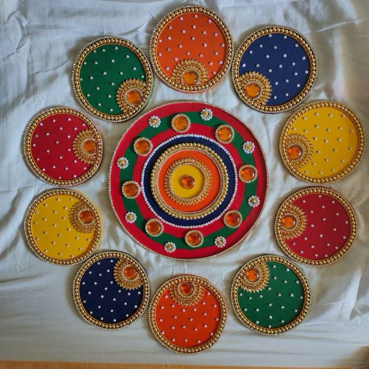 an art work is displayed on a white sheet with colorful circles and dots in the center