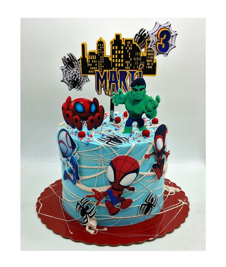 a spiderman birthday cake on a red plate