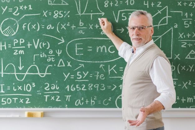 a man standing in front of a chalk board