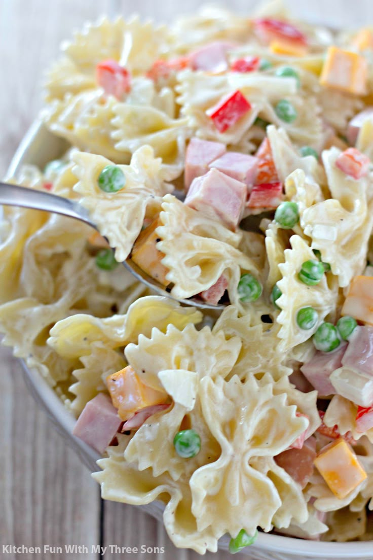 pasta salad with peas and ham in a bowl