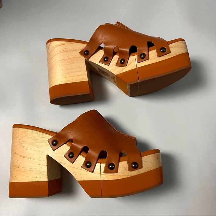 Free People Cassis Tan Clog Leather/Wood Tan Size 39 Taking Cues From The Grooviest Styles, These Platform Clogs Feature A Bold Wood Block Heel And A Two-Tone Platform Sole, Finished With A Seamed Leather Strap And Stud Detailing. Features: Slip-On Style, Backless Design, Square Open Toe, Thick Leather Toe Strap, Seamed Detailing, Two-Tone Wood Platform Sole, Chunky Block Heel, Stud Details, Lined Footbed Brown Leather Platform Mules, Brown Leather Mules With Platform, Platform Wood Clogs With Block Heel, Wooden Clogs With Stacked Heel And Round Toe, Wooden Platform Clogs With Round Toe, Wooden Platform Clogs With Block Heel, Leather Platform Clogs With Open Heel, Brown Wedge Heel Mules With Rubber Sole, Brown Mules With Rubber Sole And Wedge Heel