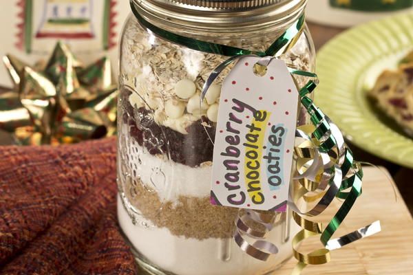 a glass jar filled with cookies and other treats