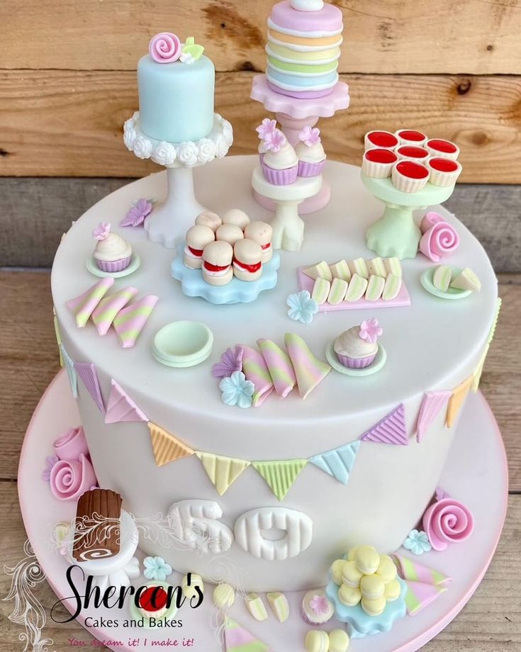 a birthday cake decorated with cupcakes and sweets