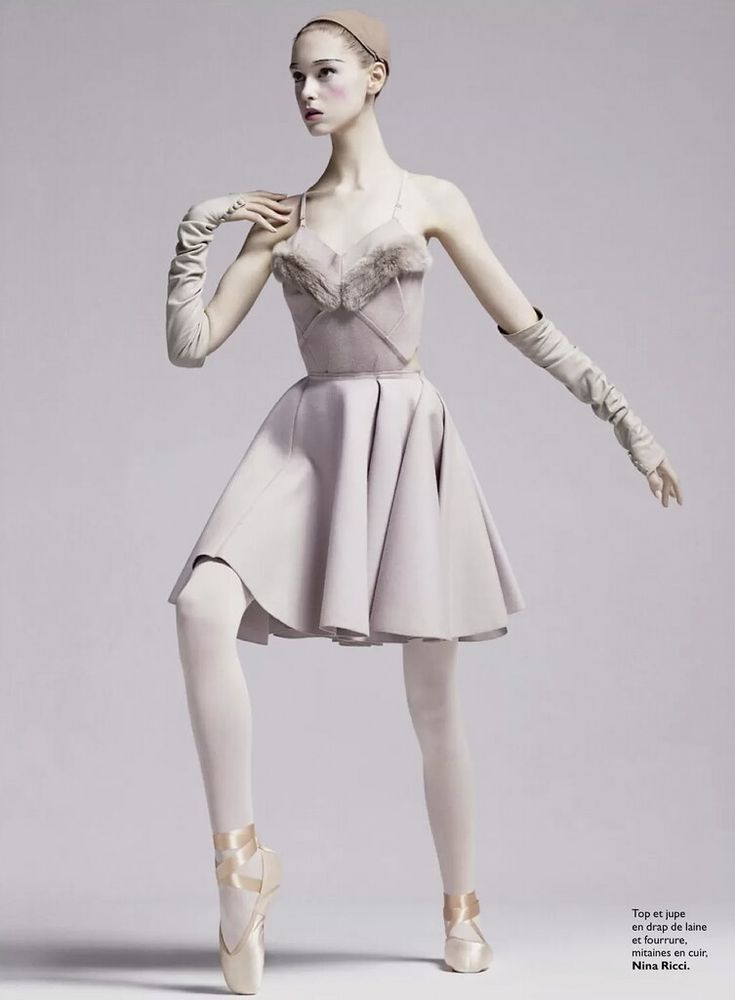 a ballerina is posing for the camera in her ballet outfit and gloves, with one hand on her hip