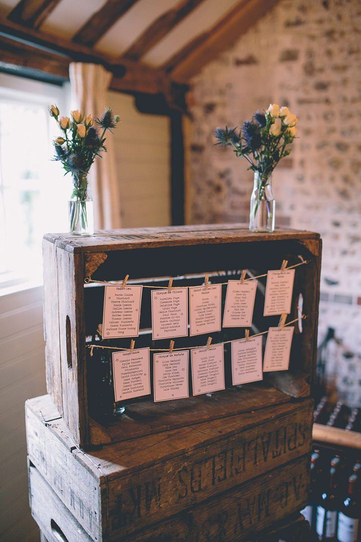 an old wooden box with notes attached to it and flowers in vases on top