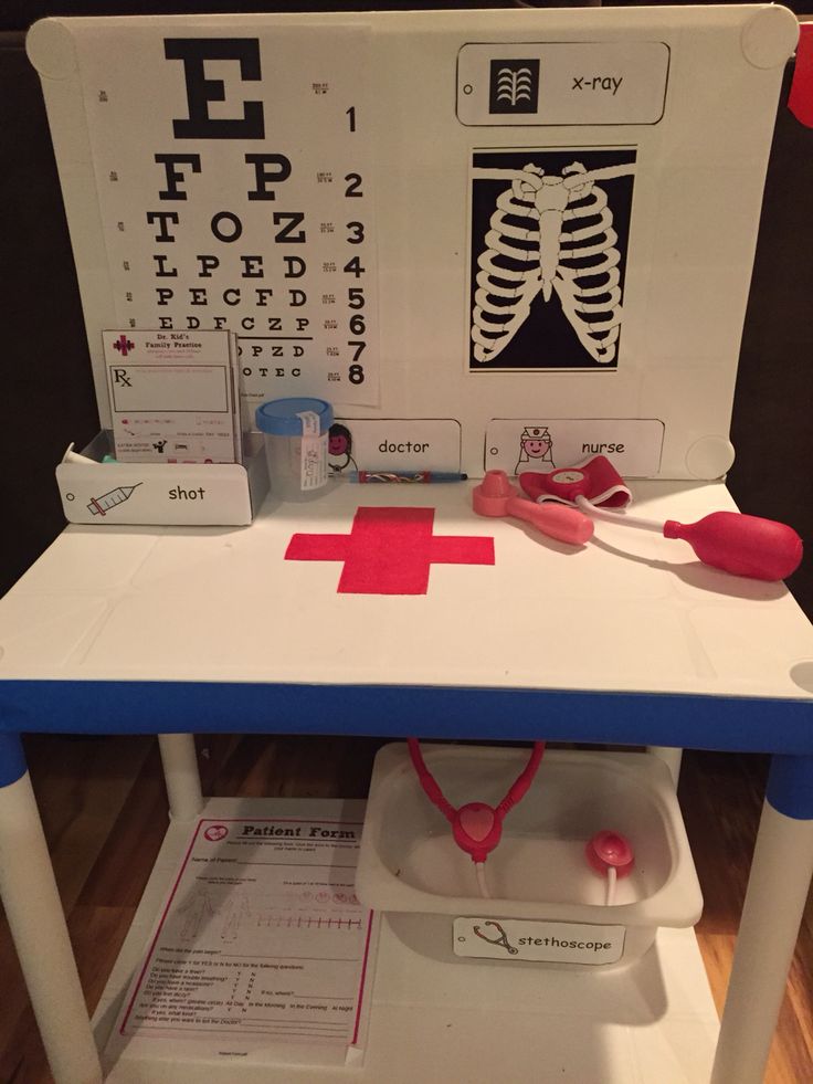 a table with an eye chart and medical supplies on it