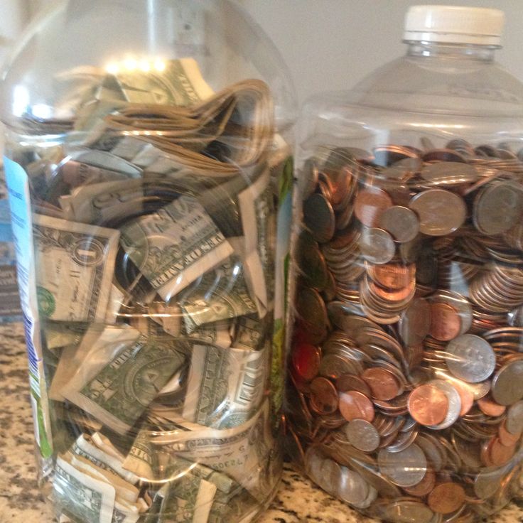 two jars filled with money sitting on top of a counter