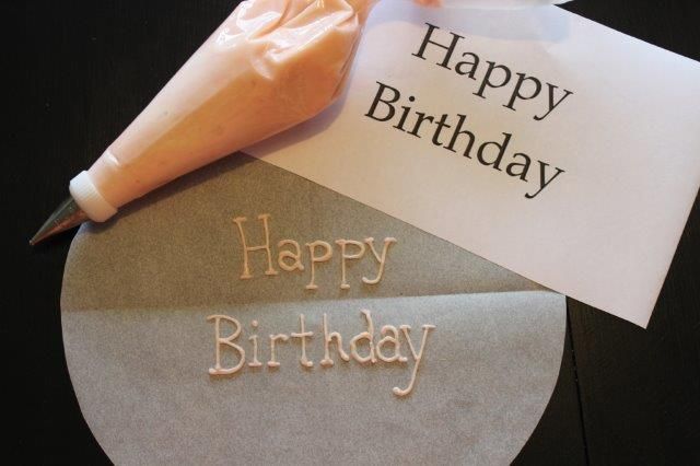 a piece of paper with the words happy birthday written on it next to a knife